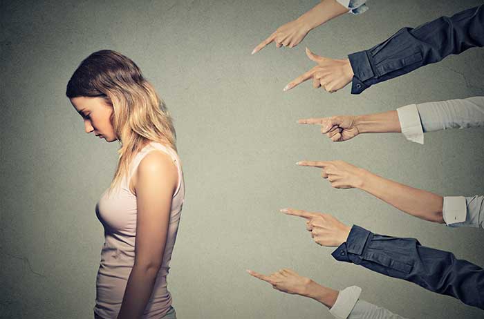 Fingers pointing at woman