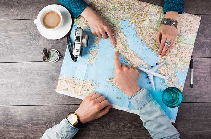 fingers pointing to spots on a map